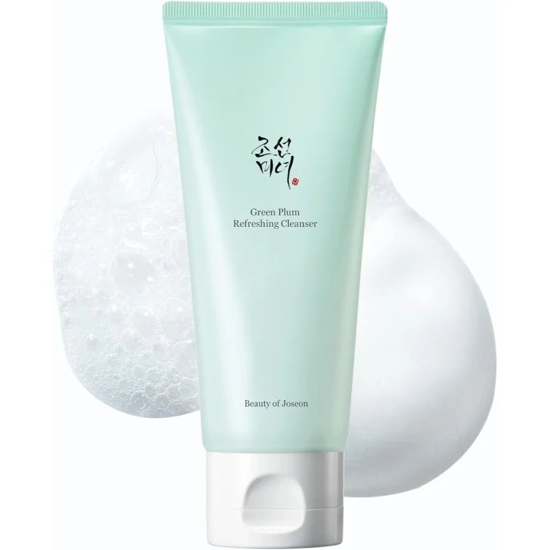 Green plum refreshing cleanser with a white sponge on a white background